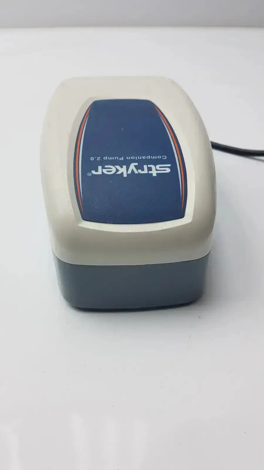 Beige and dark gray plastic Stryker Companion Pump 2.0 model 2781 with blue label and orange trim