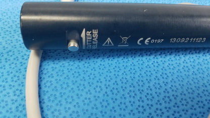 Black cylindrical stryker essx microdebrider handpiece with silver release button and white cable for reuse medical equipment