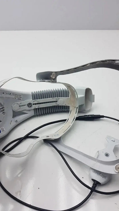 White plastic and metal stryker flyte helmet ref with black cables and skywalker branding in headband style design