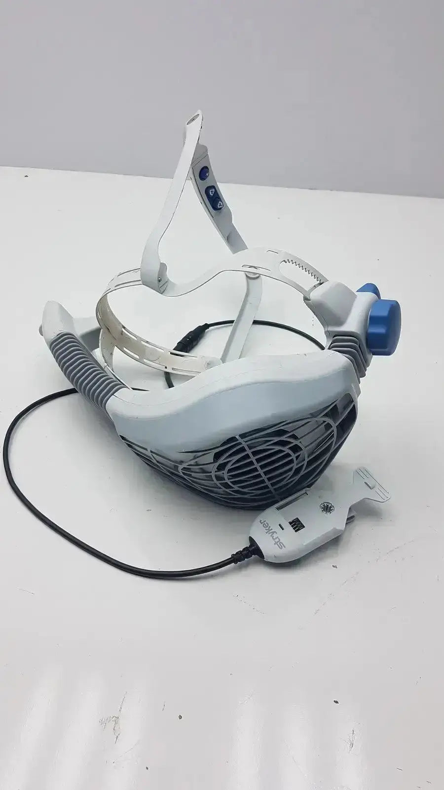 White and blue electric stryker flyte helmet ref 0408-600-000 with fan grille, adjustable straps, and control unit attached