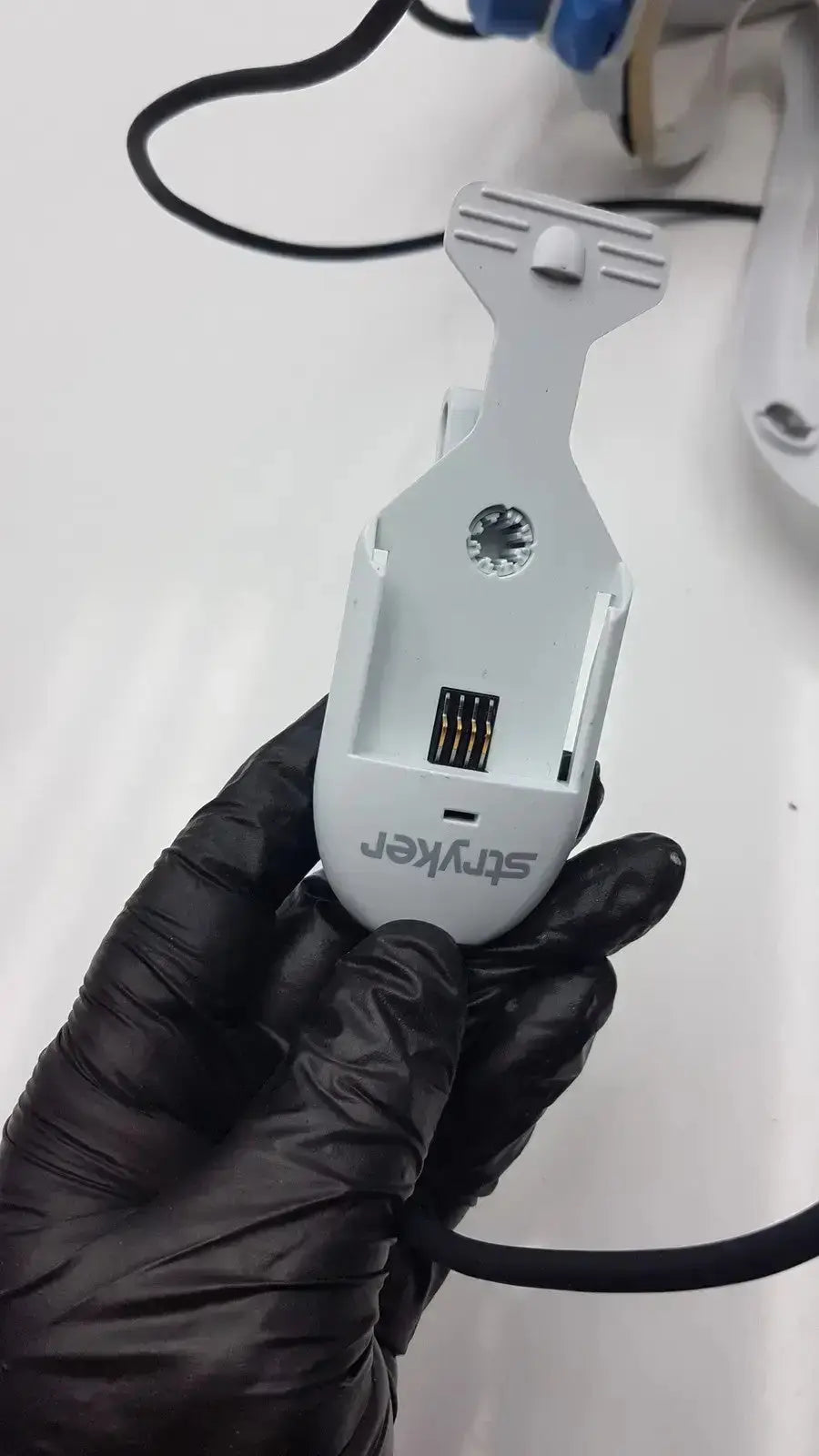 White plastic stryker flyte helmet with clip and usb port showing the back side of the medical device model 0408-645-000
