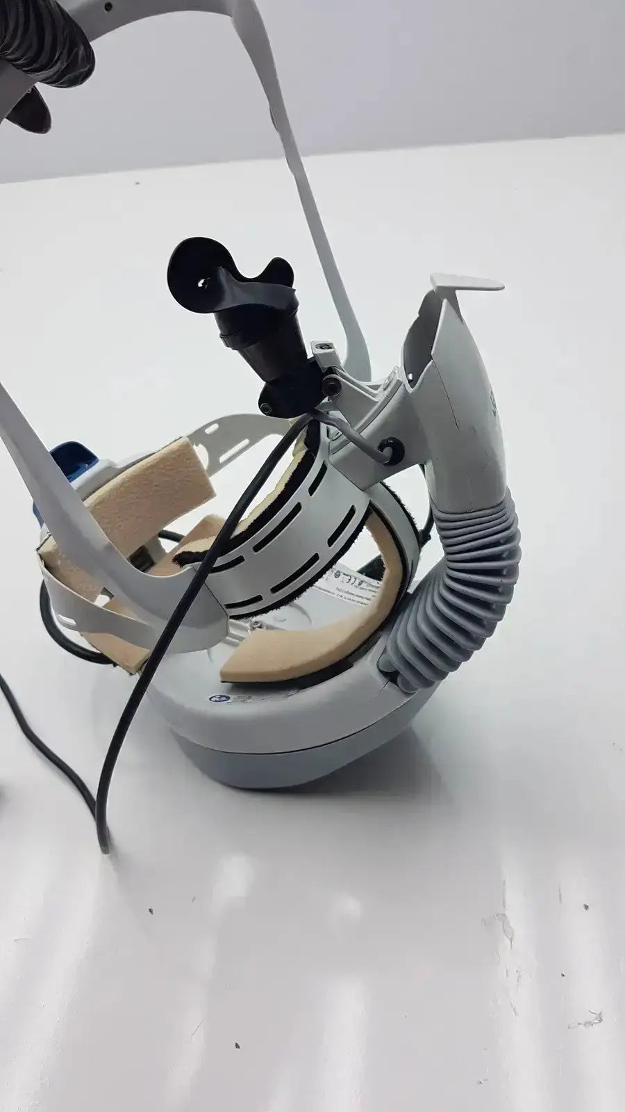 Gray and black stryker flyte helmet with adjustable straps, flexible tube, and camera mount for medical use