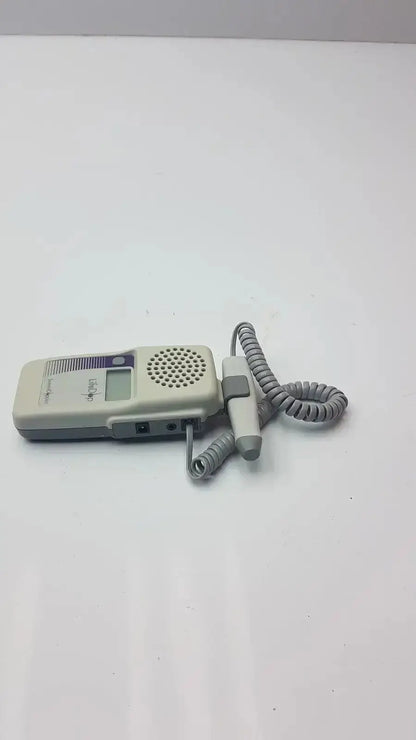 Gray and white handheld lifeDop l250ar fetal heart rate monitor with 2 MHz probe and coiled cord for prenatal use