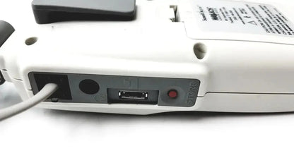 White plastic handheld summiit liifedop abi l250 vascular system showing usb port power input and red store button