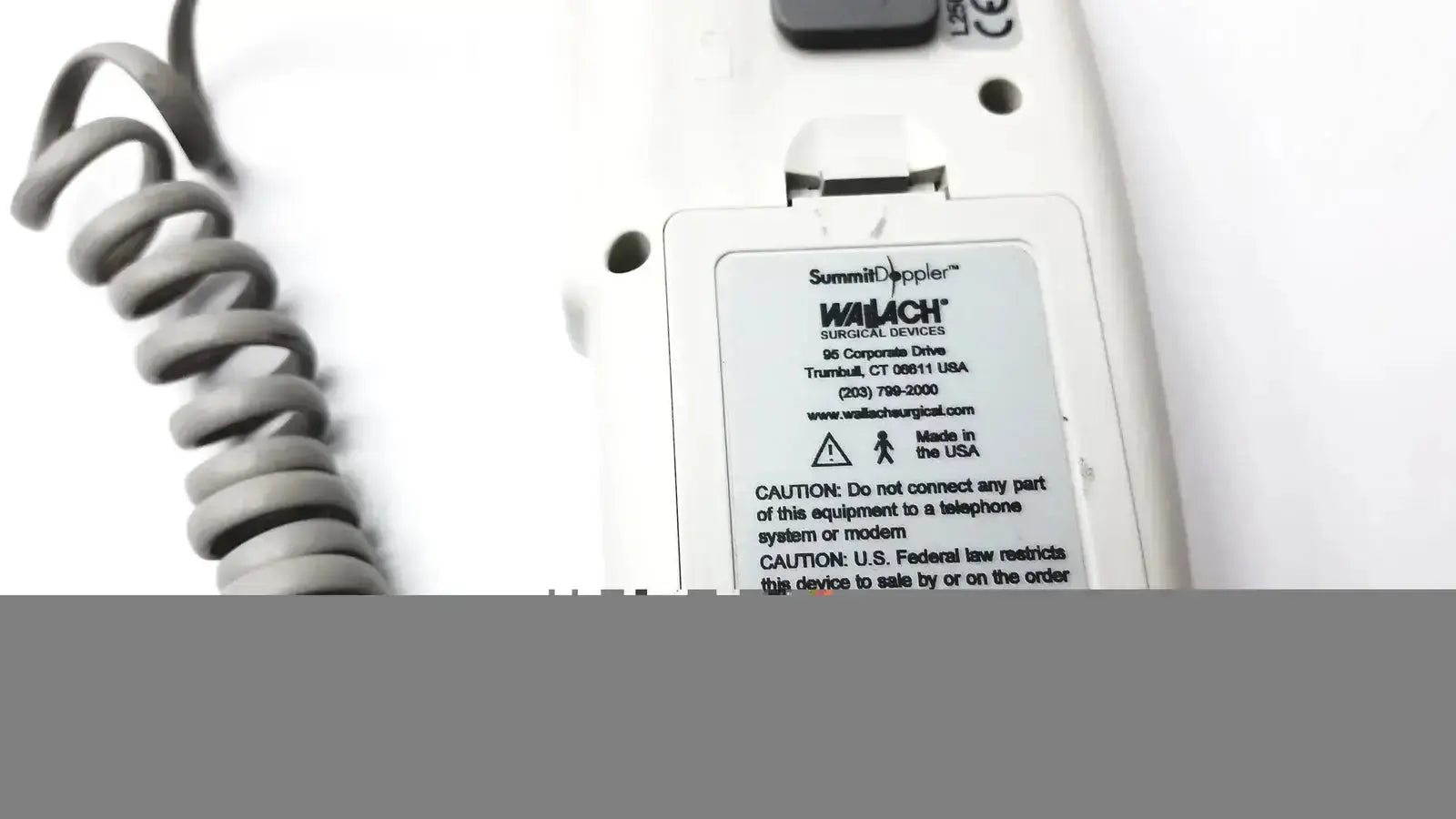 White plastic summiit liifedop abi l250 vascular system with coiled gray cord labeled walach surgical devices made in usa