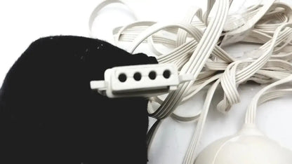 White plastic multi-pin connector for sunbeam blanket controller l78-dd2d style 85kqp nestled among beige cords