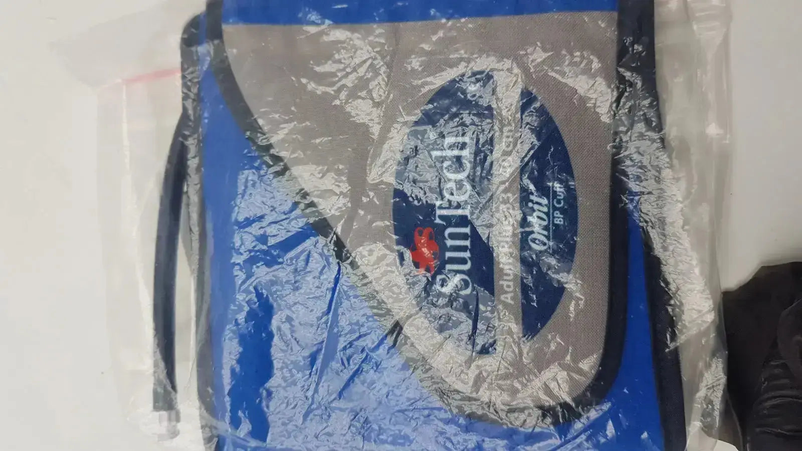 Blue and gray suntech orbit cooler bag sealed in clear plastic packaging for suntech abpm cuff adult plus range