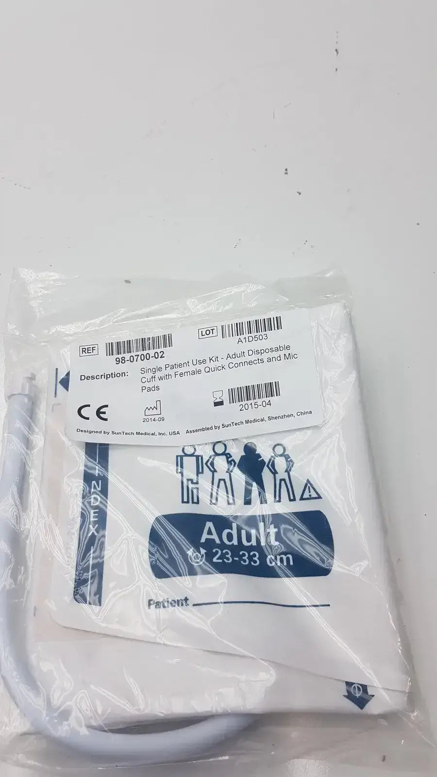 White disposable adult blood pressure cuff with blue printed labeling and measurement markings by SunTech Medical