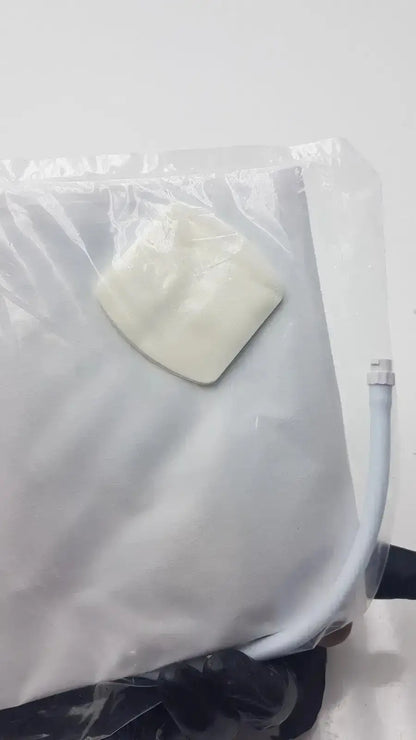 A white, soft-textured adhesive patch in a translucent bag for SunTech Medical single patient use blood pressure cuff