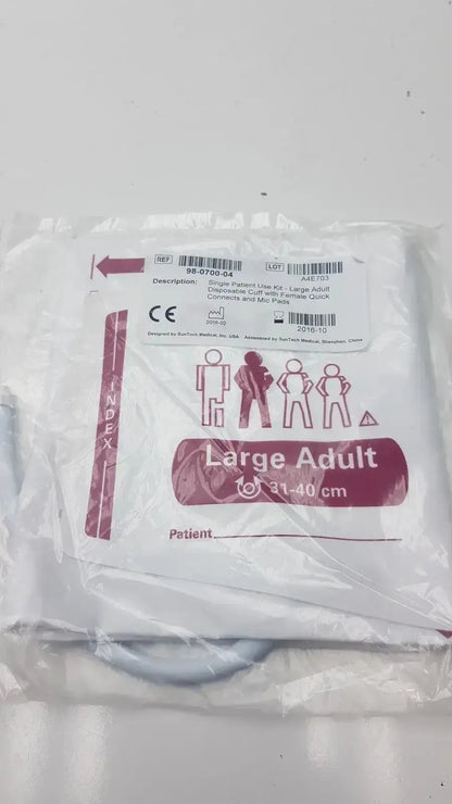 Large adult disposable fabric surgical drape in clear plastic with maroon white label for SunTech blood pressure cuff kit