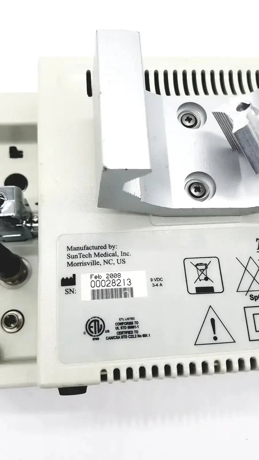 White plastic suntech medical tango bp monitor with metallic components and ventilation slots on the back side