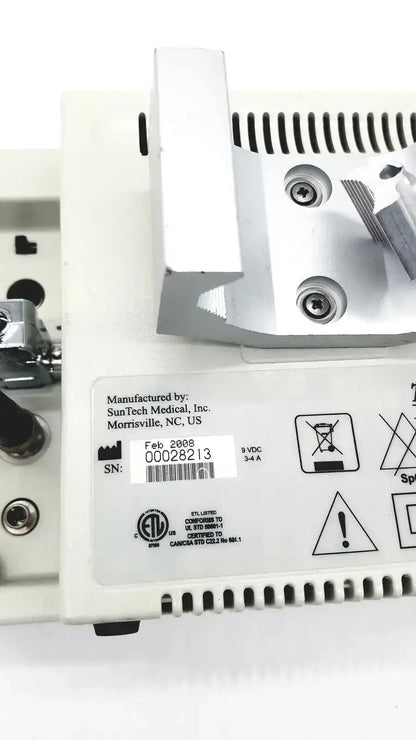 White plastic suntech medical tango bp monitor with metallic components and ventilation slots on the back side