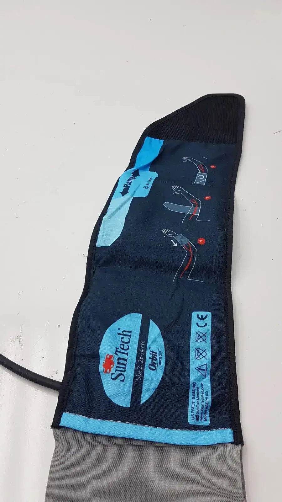 Black and blue fabric SunTech Orbit ABPM cuff size 2 with printed instructions and size range 26-34 cm