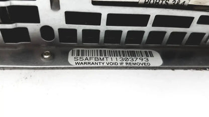 Silver metal server rack bracket with black cutouts and white serial label on the back of supermicro 5015b-mt super server