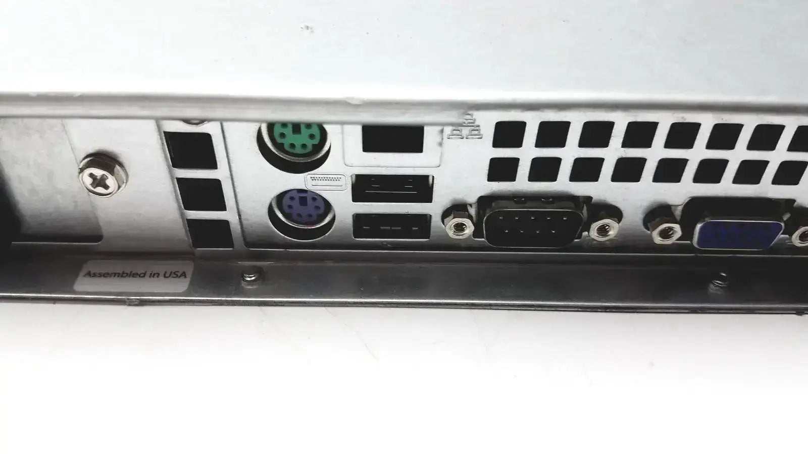 Back side of silver metal supermicro 5015b-mt super server rack with green and purple circular ports usb and vga connectors