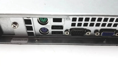 Back side of silver metal supermicro 5015b-mt super server rack with green and purple circular ports usb and vga connectors