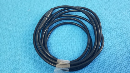 Black coiled surgical scher handpiece cable console connector with metallic connector and clear plastic tie for medical equipment