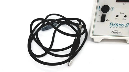 Black coiled cable with gray metallic connectors next to sybron analytic system b dental endo heat source model 1005