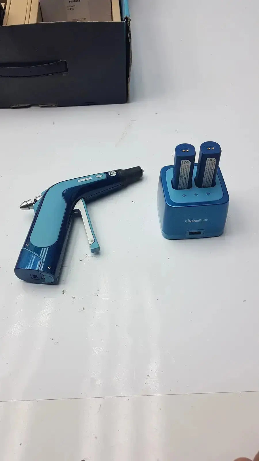 Blue sybronendo system b cordless obturation air gun with two batteries in charging base used medical equipment for sale