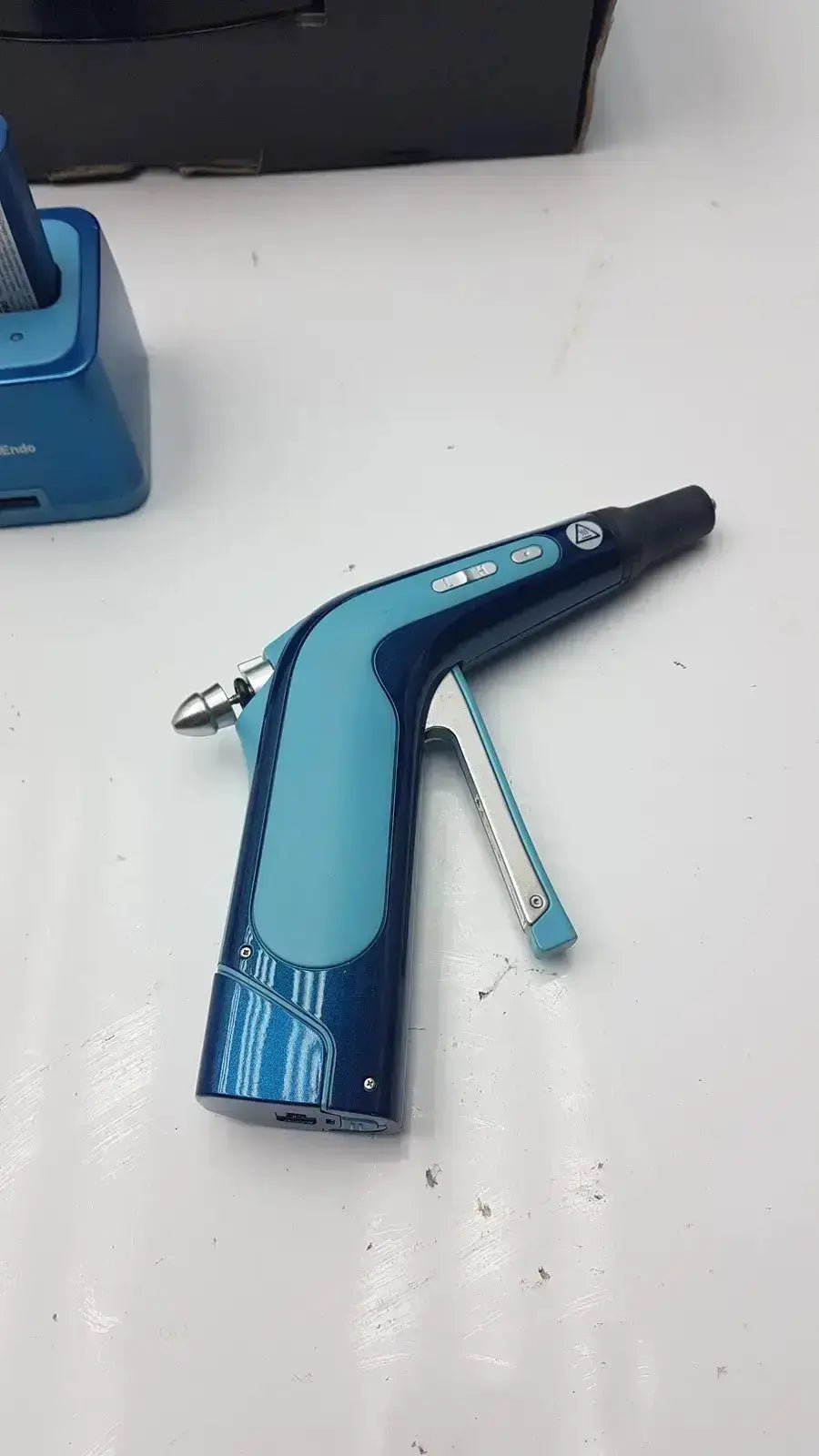 Blue and black SybronEndo System B cordless obturation handheld nail gun with ergonomic grip and digital display for dental use g-cir-r4-30f