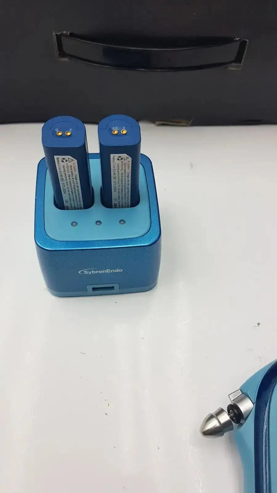 Blue rectangular sybronendo battery charger with usb port and two cylindrical batteries for cordless obturation g-cir-r4-30f used medical equipment for sale