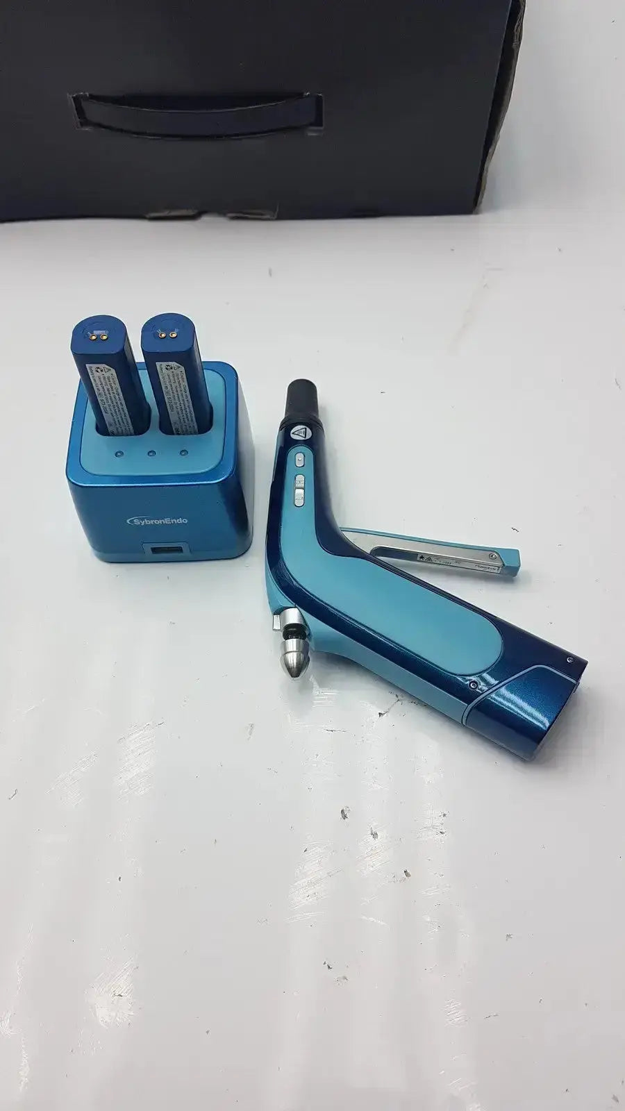 Blue handheld cordless obturation laser device with matching charger sybronendo system b g-cir-r4-30f used medical equipment for sale