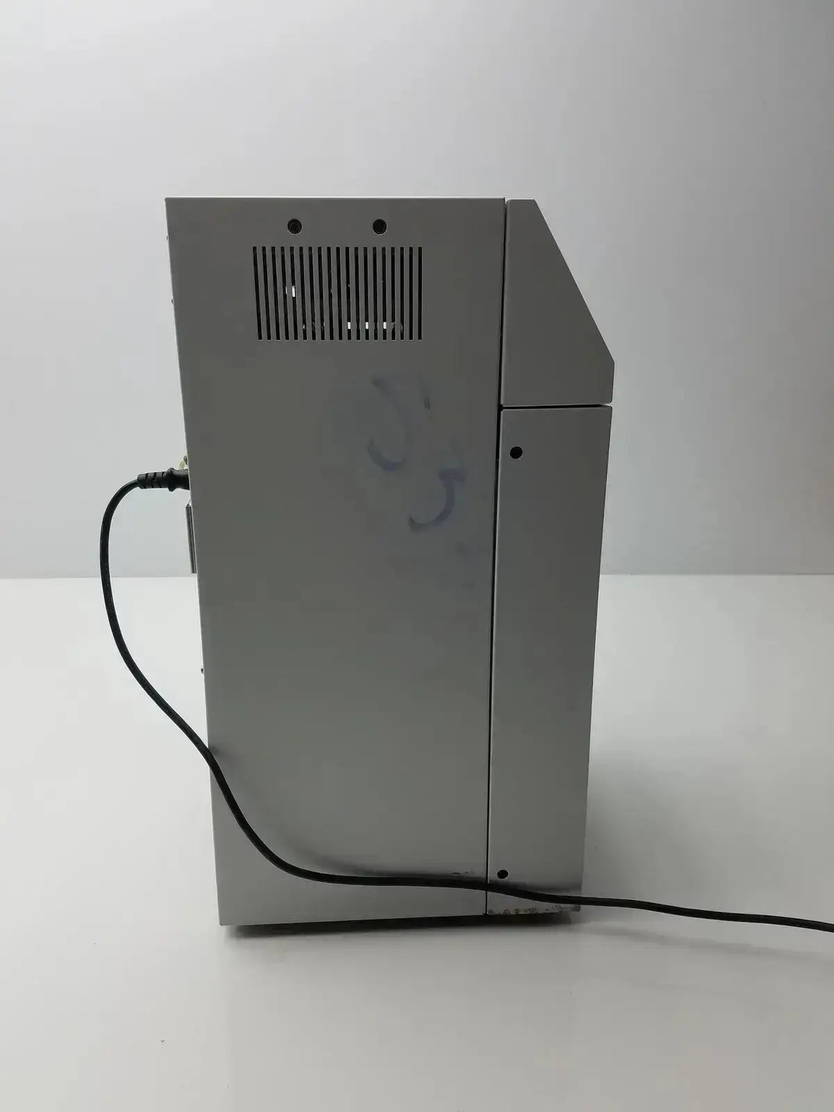 Silver metallic sysmex ru-20 reagent delivery system printer with vertical vent grille and black power cord back side view
