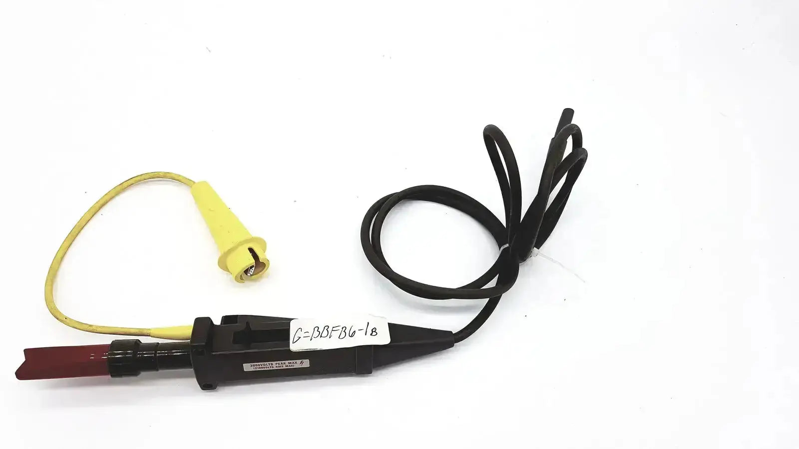 Black and yellow Tektronix electrical test probe with red tip and coiled cable rated for 3000 volts peak max and 2100 volts rms max