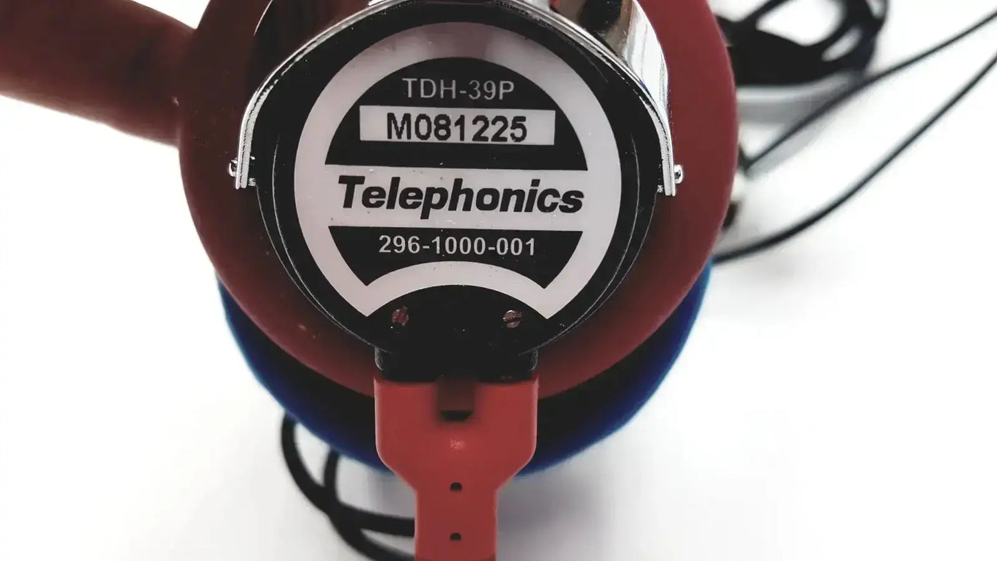 Red and blue telephonics tdh-39p audiometric earphones with circular label showing model number and contact info