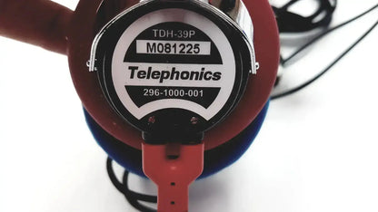Red and blue telephonics tdh-39p audiometric earphones with circular label showing model number and contact info
