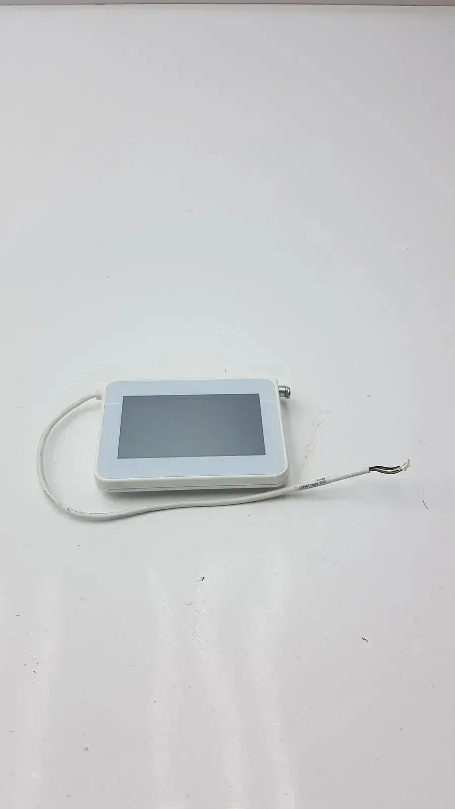 White rectangular tft hmi lcd nextion device with screen and coiled cable in a mounting frame for easy installation