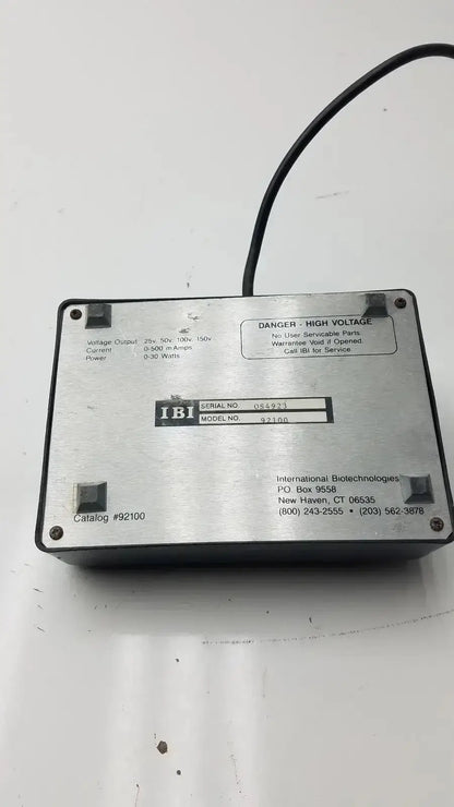 The back side of a silver metallic ibi cps 500 compact power supply model 92100 with black cable and printed specs
