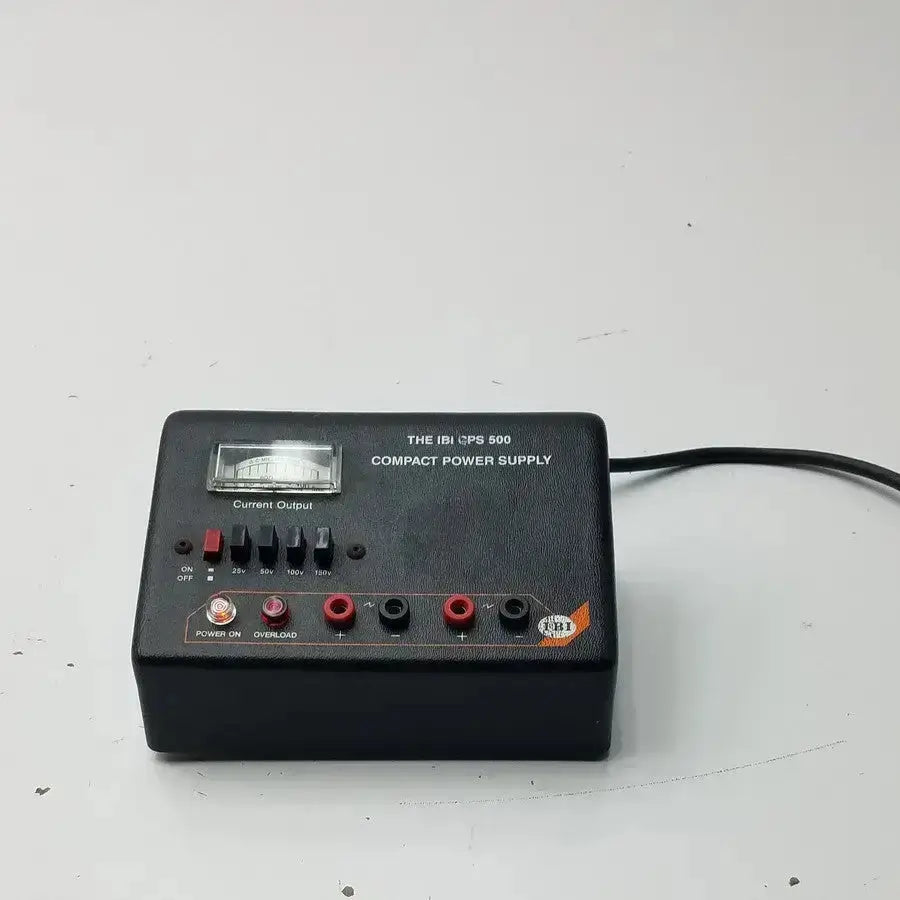 The ibi cps 500 compact power supply model 92100 is a black rectangular unit with analog meter and multiple output jacks
