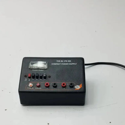 The ibi cps 500 compact power supply model 92100 is a black rectangular unit with analog meter and multiple output jacks