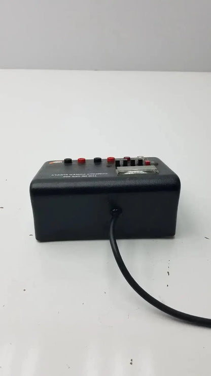 The ibi cps 500 compact power supply is a black rectangular device with red and black knobs a silver label and power cord