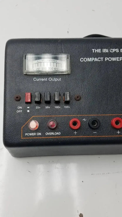 The IBI CPS 500 compact power supply model 92100 features a black leather-textured case with silver dial and red black terminals