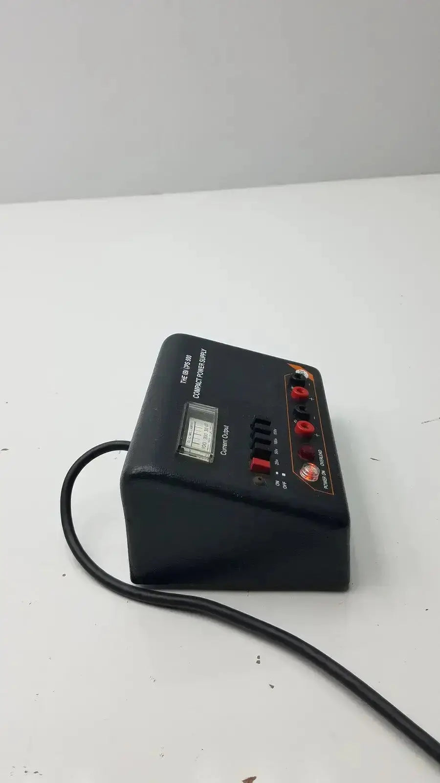 Black rectangular ibi cps 500 compact power supply with digital display red and black knobs and multiple input output ports