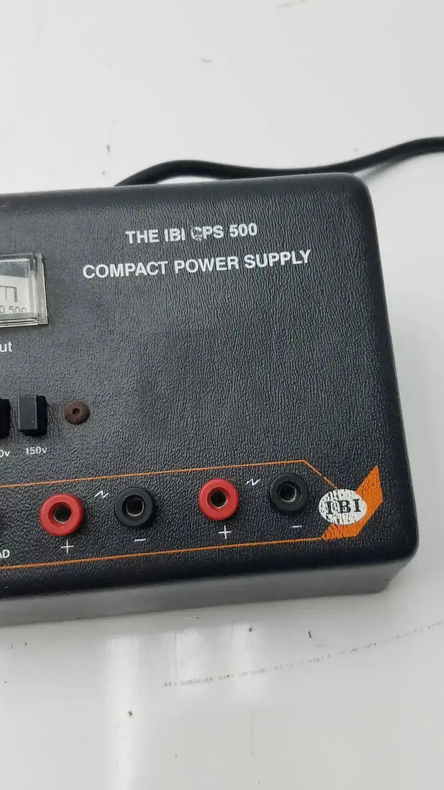 The ibi cps 500 compact power supply model 92100 is a black unit with red and black output terminals