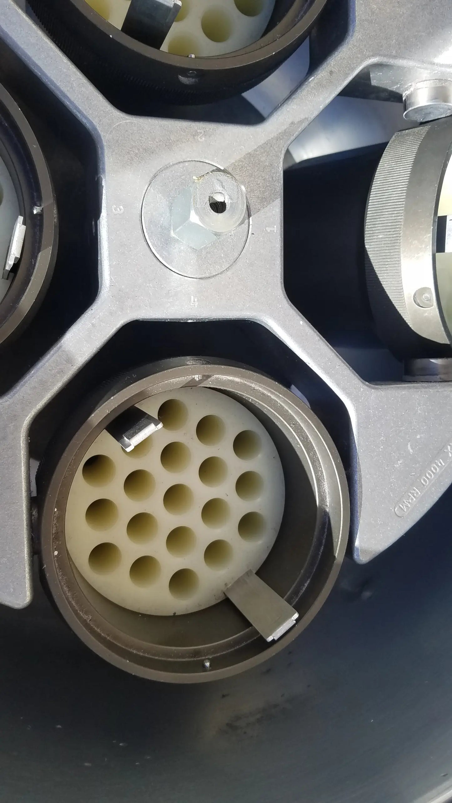 Gray metallic connector housing with white plastic insert and multiple circular ports for silent solution silencer 2310 centrifuge system medical equipment
