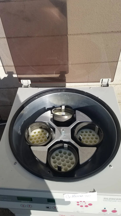 Silver and black silent solution silencer 2310 centrifuge system with four circular sample holders for medical equipment use