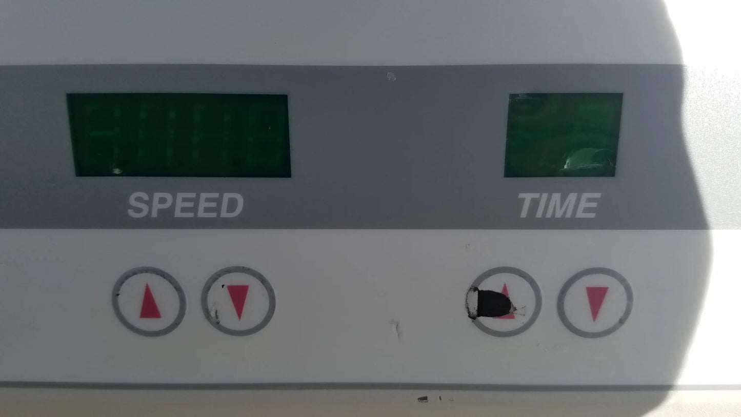 White digital control panel with green lcd screens and red buttons on the silent solution silencer 2310 centrifuge system for medical equipment reuse