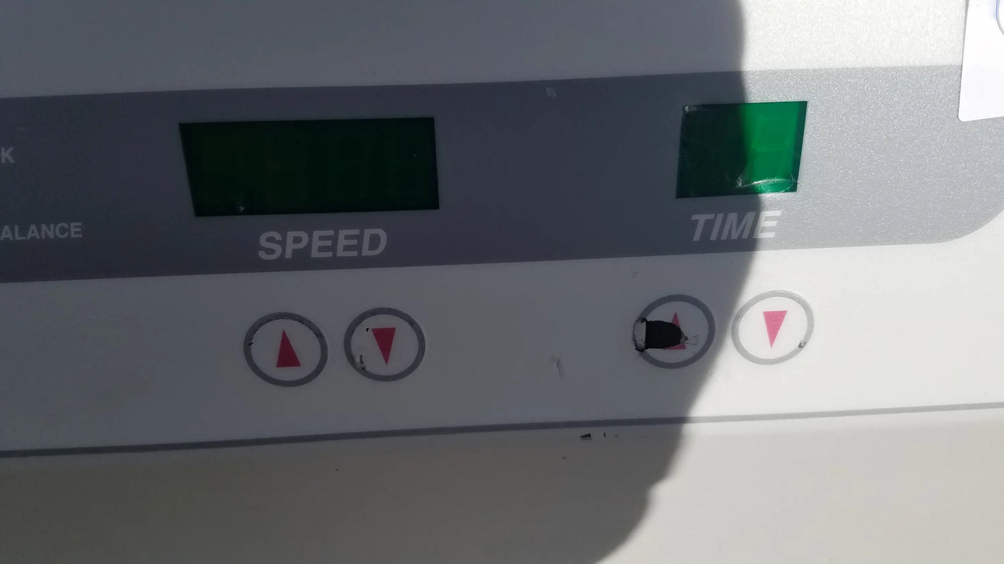 White exercise machine control panel with digital speed and time displays red arrow buttons and green light on silent solution silencer medical equipment