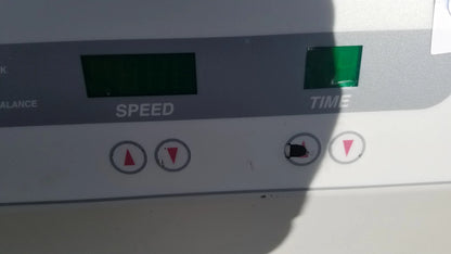 White exercise machine control panel with digital speed and time displays red arrow buttons and green light on silent solution silencer medical equipment