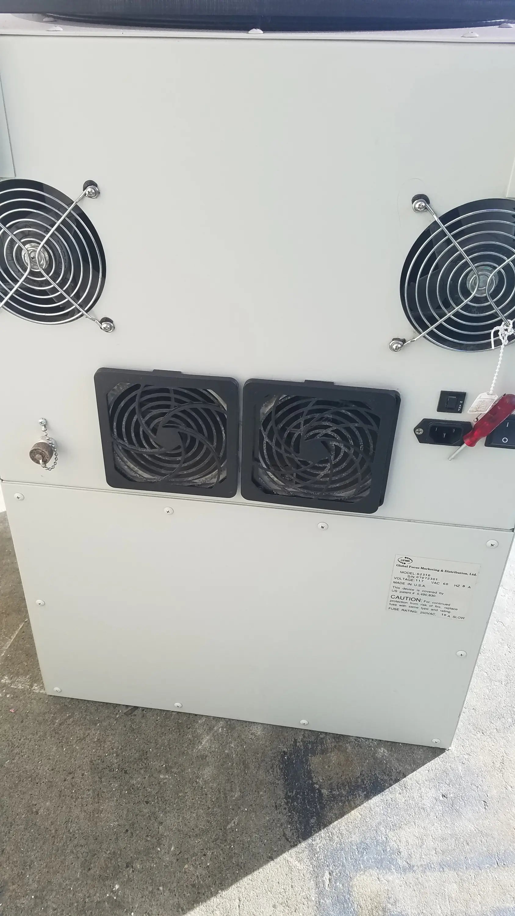 White industrial-grade server rack with four black fans and power panel at back of silent solution silencer 2310 centrifuge system