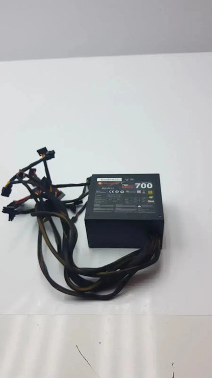 Black thermaltake tr2 700w atx 12v power supply unit with multiple black cables and 700 label on top surface