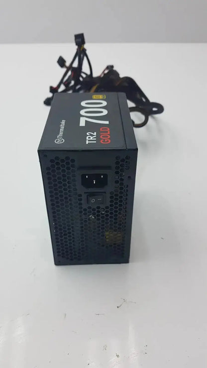 Black thermaltake tr2 700w atx 12v power supply unit with perforated front panel and bundled cables for desktop use