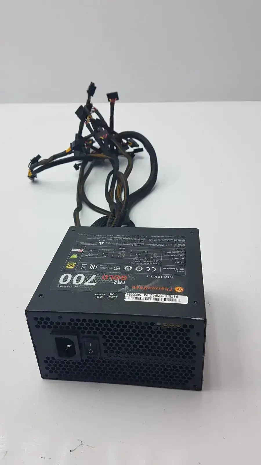 Black rectangular thermaltake tr2 700w atx 12v power supply unit with 700 and trx branding on label for desktop use