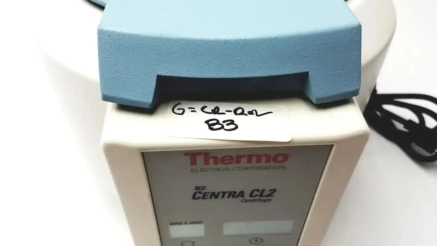 Light blue plastic lid on white thermo electron corporation iec centra cl2 centrifuge model for laboratory use