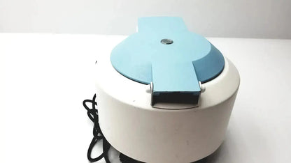 White and light blue electric waffle maker with hinged lid and black power cord by thermo electron for iec centra cl2 use