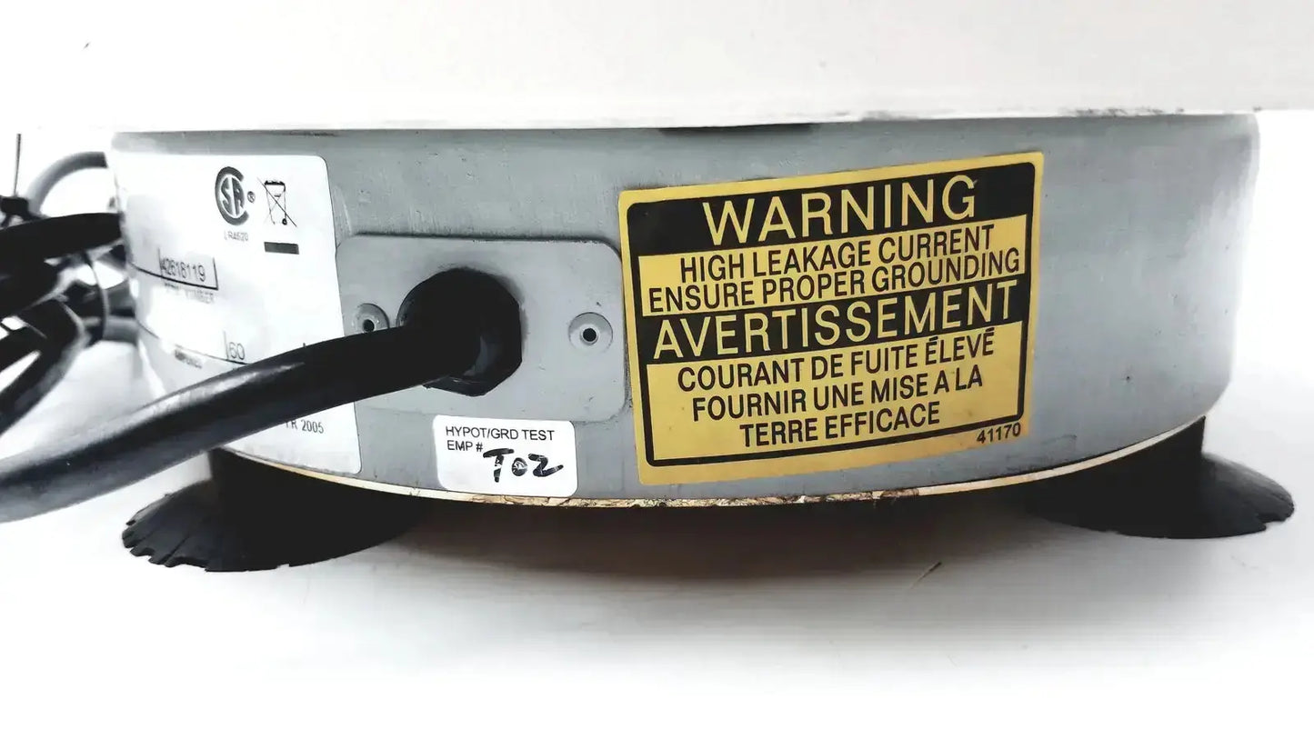 Gray metallic circular iec centra cl2 centrifuge device with black rubber feet and bilingual warning label visible